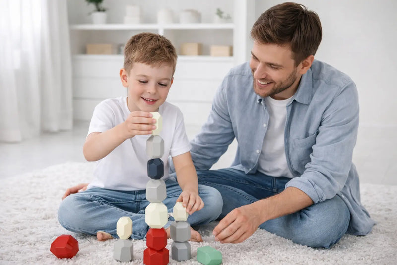 Father helping his son build concentration and problem-solving skills with stacking blocks.