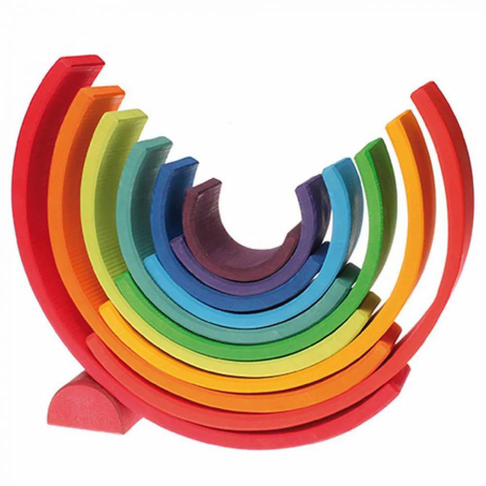 Colourful wooden toy rings stacked in a rainbow pattern