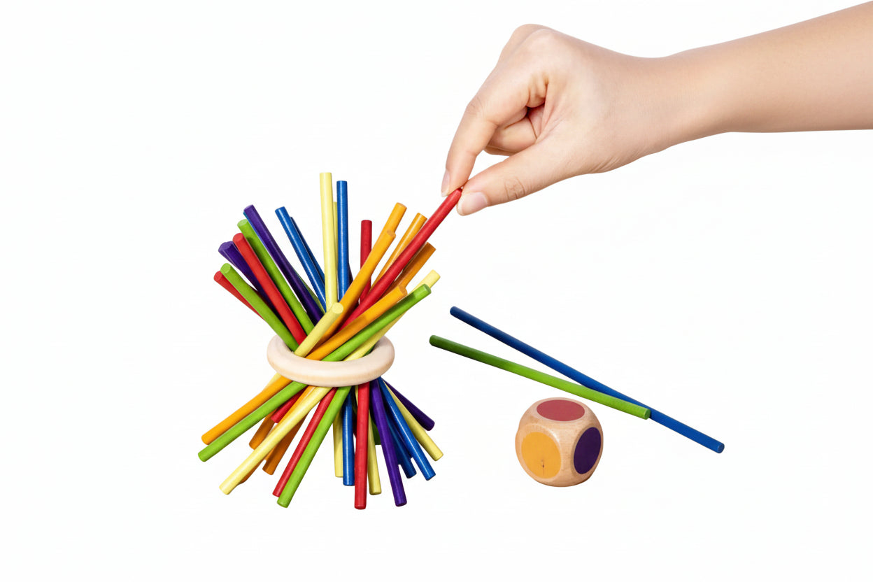 Hand arranging colourful sticks
