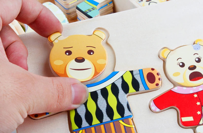Hand with a bear puzzle piece on a wooden surface.