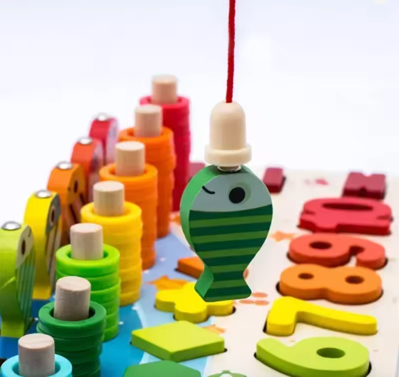 Colourful wooden toys including a fish-shaped block and number blocks