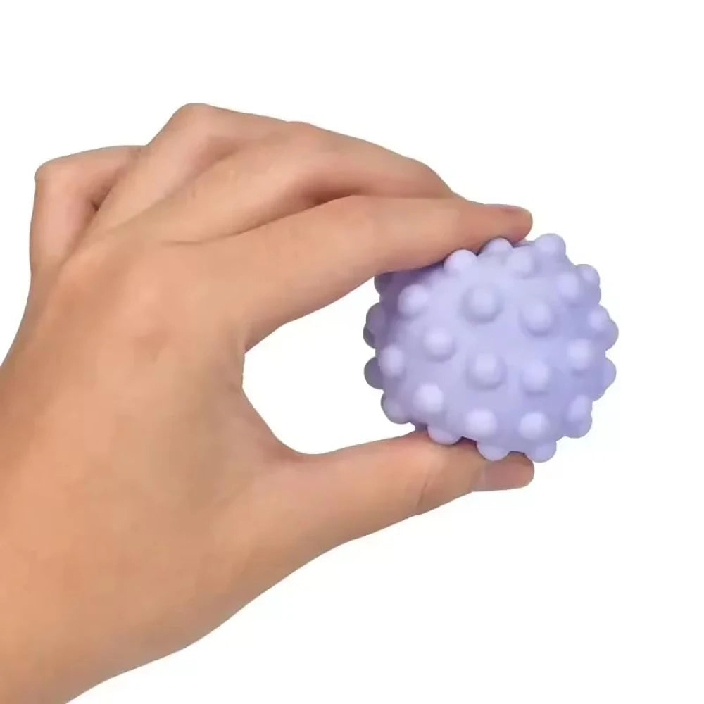 Hand holding a purple textured ball