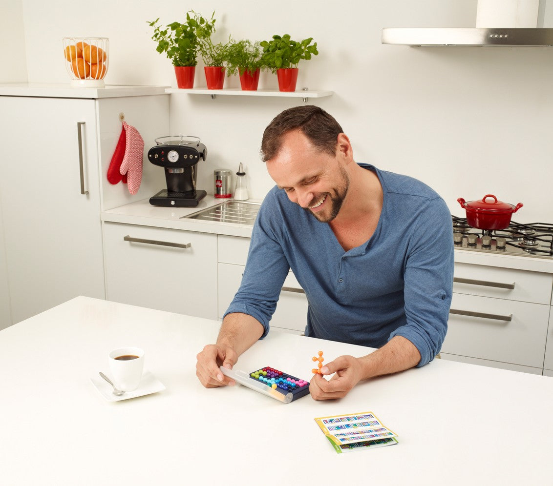 Adult demonstrating 3D brain teaser puzzle solution