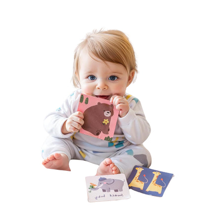Baby girl playing independently with sensory tissue box