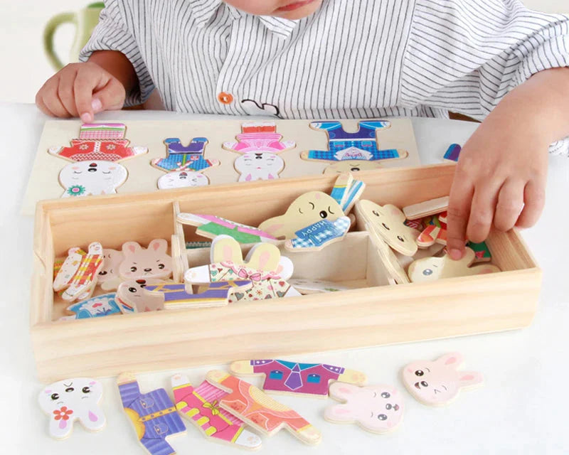 Child playing with a wooden bear dress-up puzzle toy
