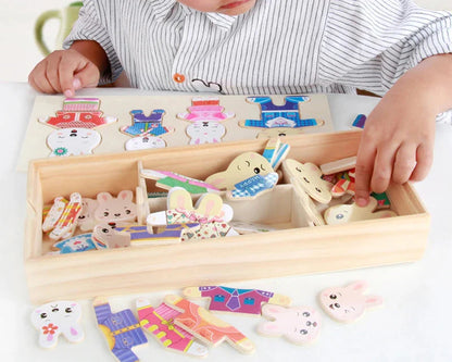 Child playing with a wooden bear dress-up puzzle toy
