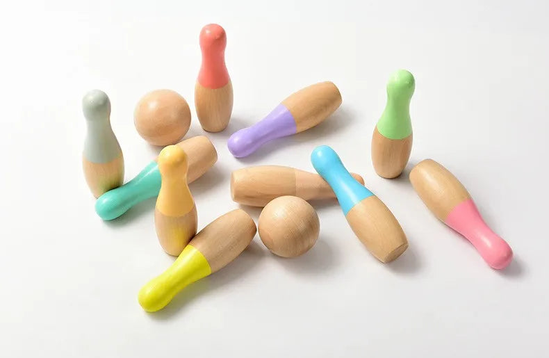 Colourful wooden bowling pins arranged upright