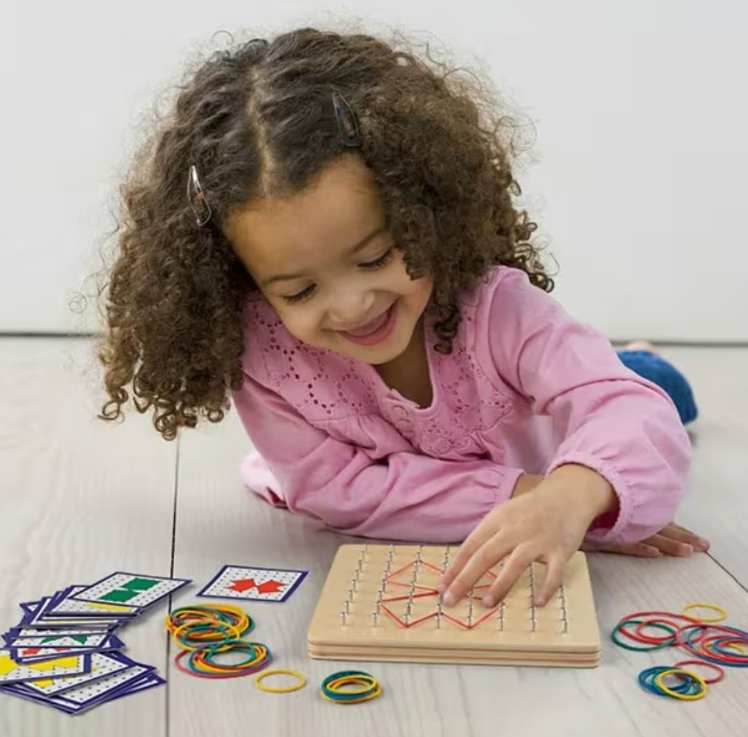 Child playing with Montessori geometric nail board