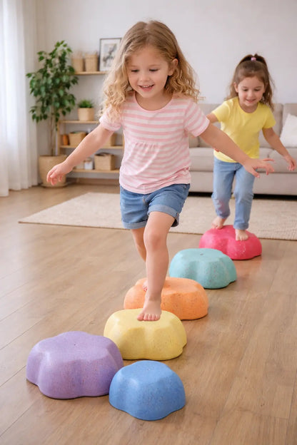 Girls playing actively with Montessori balance stepping stones indoors
