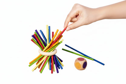 Hand arranging colourful sticks 
