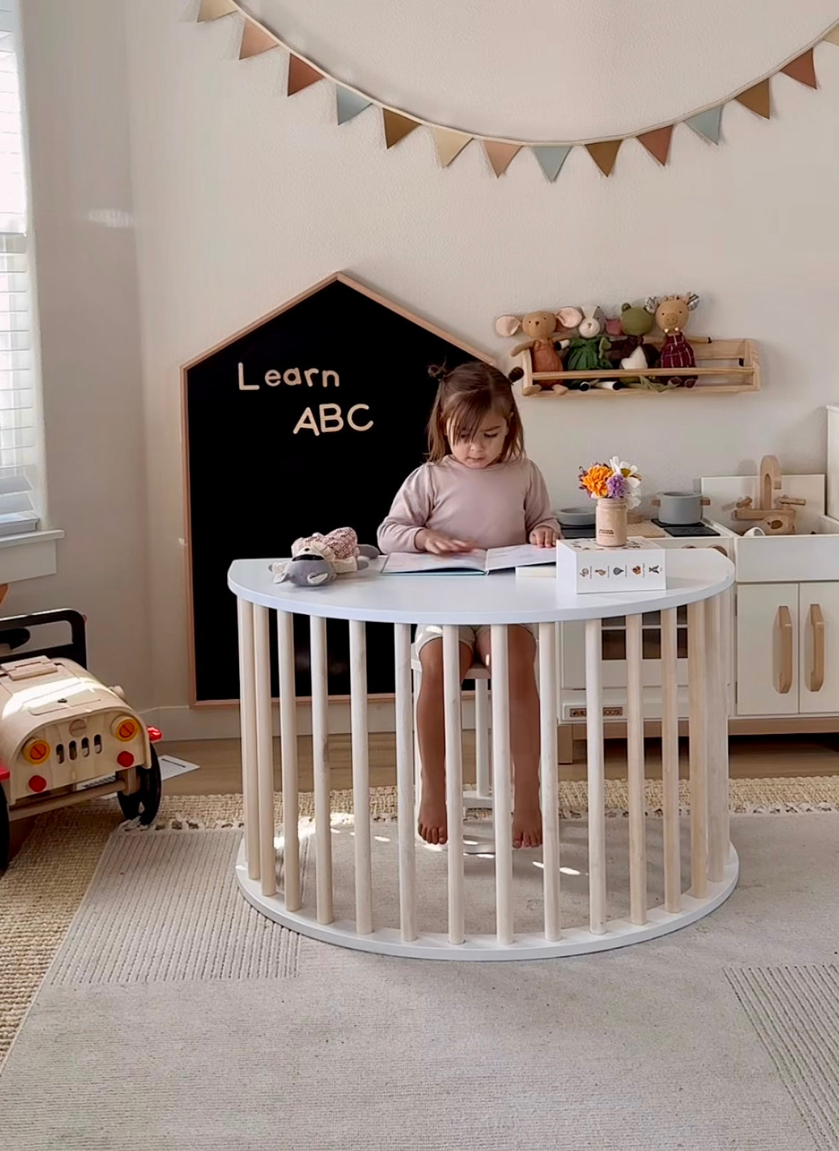 Child climbing wooden Montessori arch
