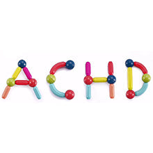 Child building large structures with 128 piece magnetic rods and balls set