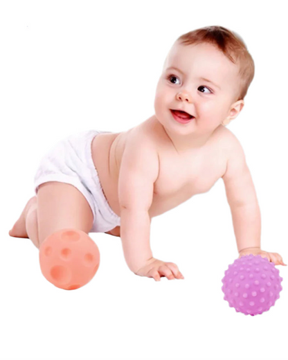Baby playing with colourful textured balls 